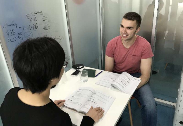 Teacher and student in classroom during Chinese class