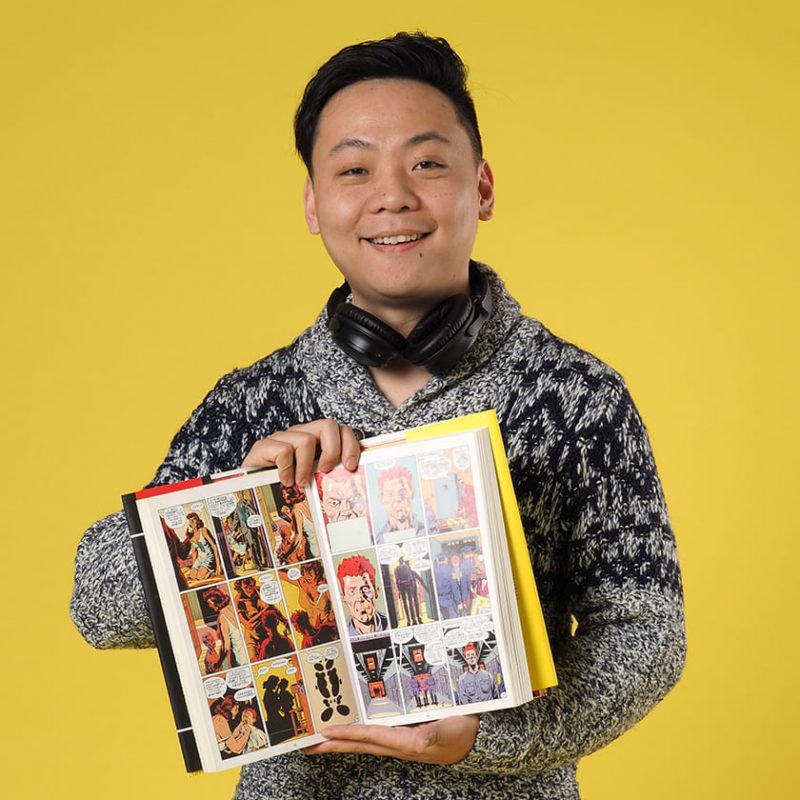 Teacher Tony holding a comic book