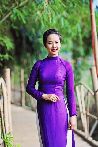 Woman wearing a purple Ao Dai in Vietnam